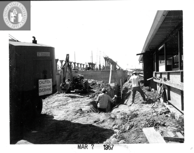 Putting in sewer line, Aztec Center, 1967