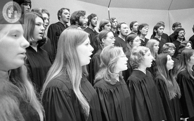 A chorus in black robes during a performance