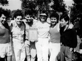 Group of people hold a plaque at Pride festival, 1986