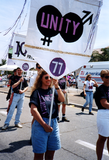 Connie holds banner in Pride parade, 1994