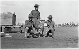 Soldiers pose with goat
