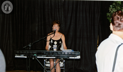 Performer playing keyboard at Pride rally, 2001