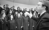 A conductor directs his chorus