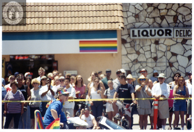 Individuals ride on a convertible in the Pride parade, 1998