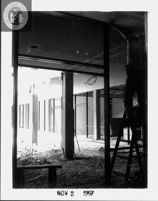 Installing window and door frames, Aztec Center, 1967