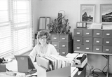 An unidentified woman at her desk
