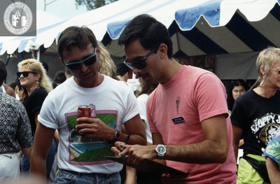 Peter Cooper, AIDS Foundation of San Diego, signs someone up, 1991