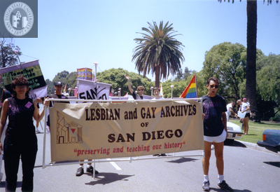 Frank Nobiletti holds Lesbian and Gay Archives of San Diego banner, 1992