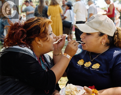 Women feeding each other cake at Commitment Ceremony, 2002