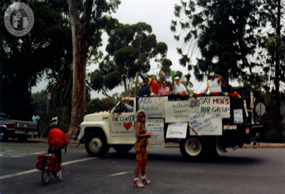 Participants waving from The Center float at Pride parade
