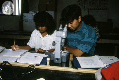 Student uses microscope in science laboratory