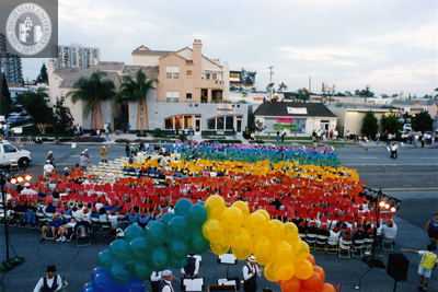View of a rainbow card stunt seen from top of The Center at Pride rally