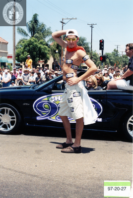 Man posing with 93.3 FM car in the Pride parade, 1997