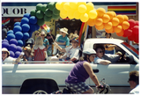Participants wave from a truck on Pride parade route, 1999