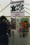 Person with television camera at exhibit, Lesbian and Gay Archives, 1991
