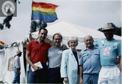 Jess Jessop outside Lesbian and Gay Archives tent at Pride festival, 1989