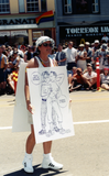 Cartoon drawing poster at Pride parade, 1999