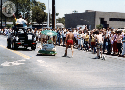Woman on mini float being pulled by a truck in Pride parade, 1988