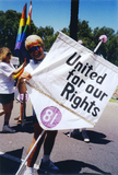 Volunteer holds flag with 1981 pride theme in Pride parade, 1992