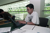 Student using laptop in the Library Addition
