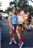 Men in matching rainbow skirts at Pride festival, 1996