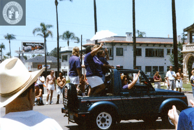 Cynthia Lawrence-Wallace in back of Jeep at Pride parade, 1995