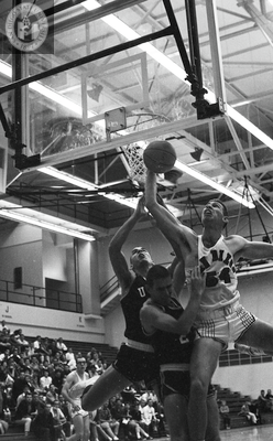 A State player reaches toward the basket