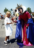 Evil Queen from Snow White gives child an apple in Pride parade, 1996