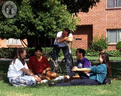 Students near a brick dormitory