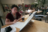Student with book in Aztec Center, 1996