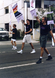 John Richardson, Glen Dake, and Jim Ely holding banners at Pride parade, 1990
