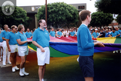 Men carrying the rainbow flag in Pride parade, 1991