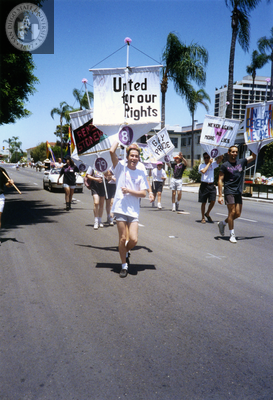 Members of the Lesbian and Gay Archives of San Diego parade group run, 1992