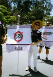 Sharon Parker holds a flag with the 1989 Pride parade theme, 1991