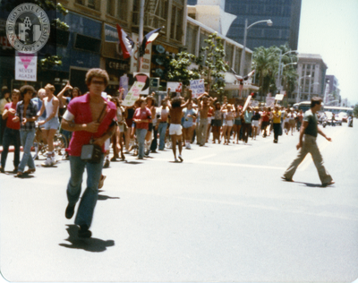Marchers hug curb in Pride parade, 1978
