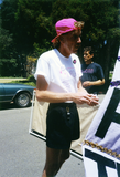 Lesbian and Gay Archives of San Diego volunteer touches up a flag, 1992