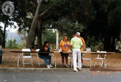 Volunteers at registration tables at Pride festival, 1998