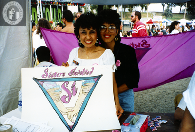 Roberta and Maria holding "Sisters Involved" sign at Pride festival, 1992