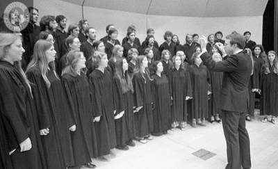 An unidentified conductor and chorus