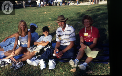Family on the grass during Family Weekend, 2000