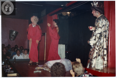 People onstage with one on floor at Men's Center Fundraiser, 1982