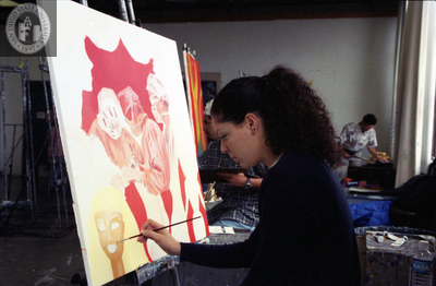Student works on painting in art class, 1996
