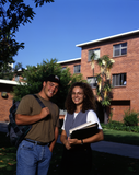 Students near a brick dormitory