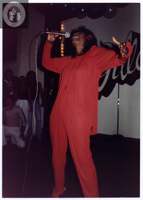 Individual singing with head back and arm outstretched, 1982