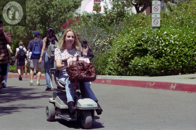 Woman on power mobility scooter, 1996