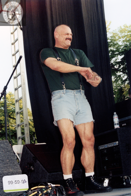 Pride staff member in front of sound equipment, 1999