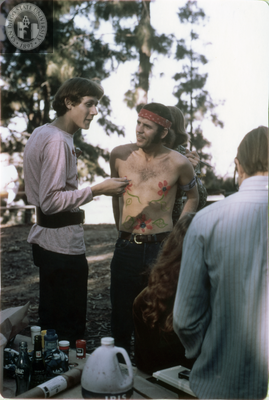 Person at body painting booth at San Diego's first Gay-In, 1970