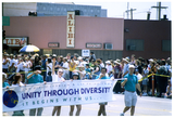 Sheila Clark and Judy Reif with banner in Pride parade, 1998