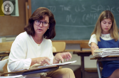 Instructor in classroom with students in a circle, 1996