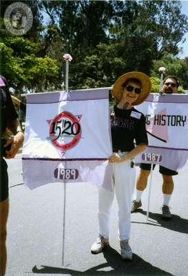 Sharon Parker holds a flag with the 1989 Pride parade theme, 1991